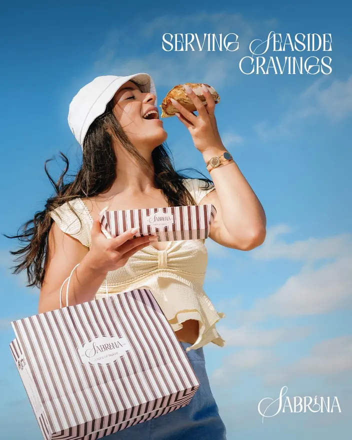Serving seaside cravings, a customer with a Sabrina box against the Alexandria sky