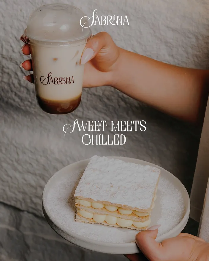 Sweet meets chilled, an iced coffee held beside a millefeuille